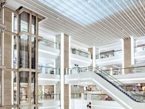 Interior of a mall with an escalator near Amara Sanctuary