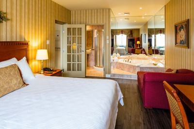 bed in spacious hotel suite with bathtub