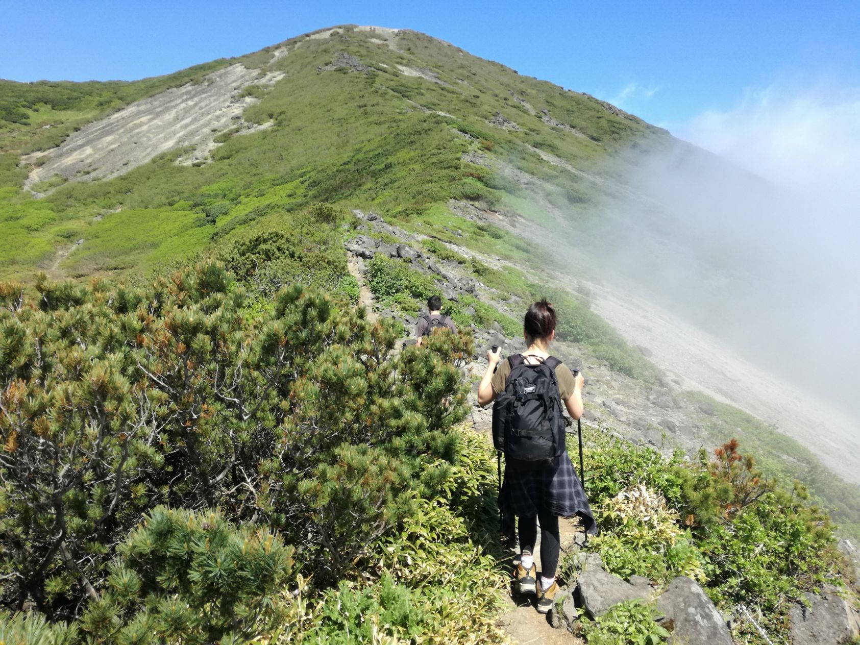 A woman hiking on a mountain near Chatrium Niseko japan