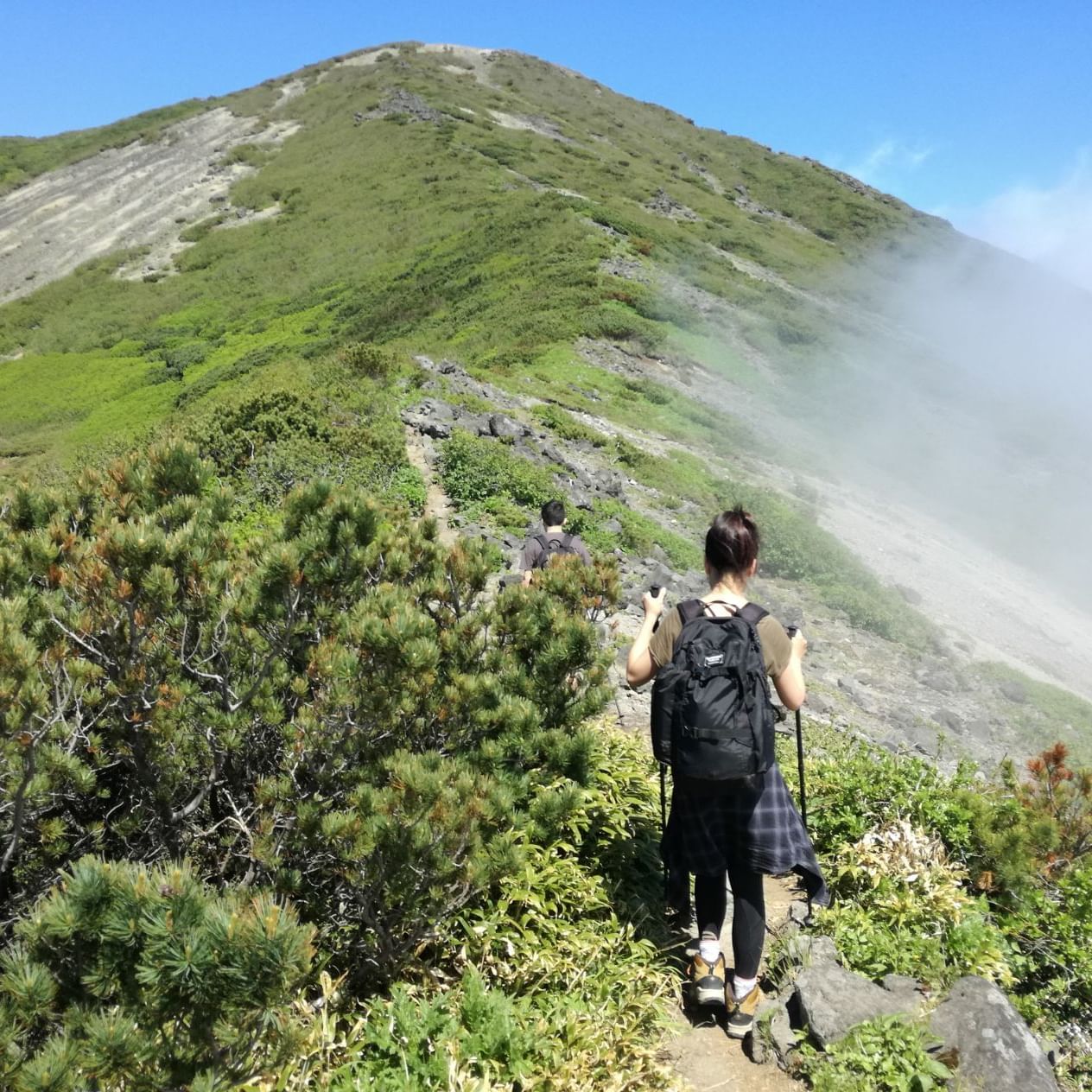 A woman hiking on a mountain near Maitria Hotel Sukhumvit 18