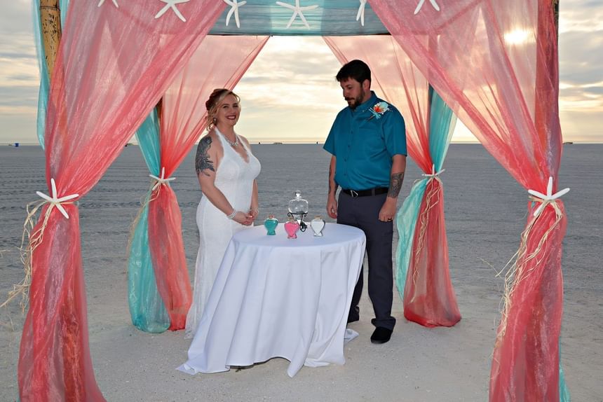Wedding couple under wedding dome at Thunderbird Beach Resort
