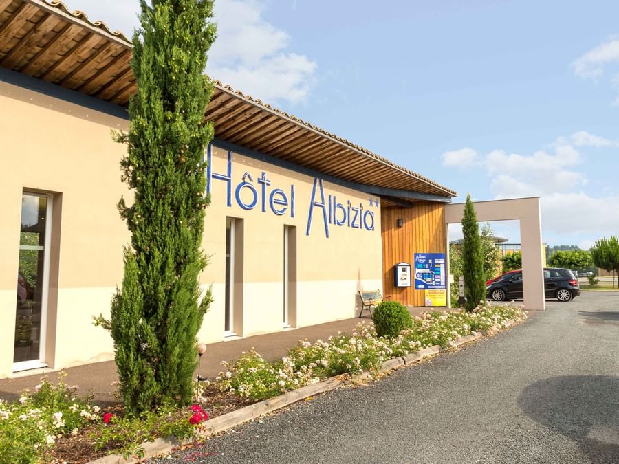 An exterior view of The Hotel and car park at Hotel Albizia