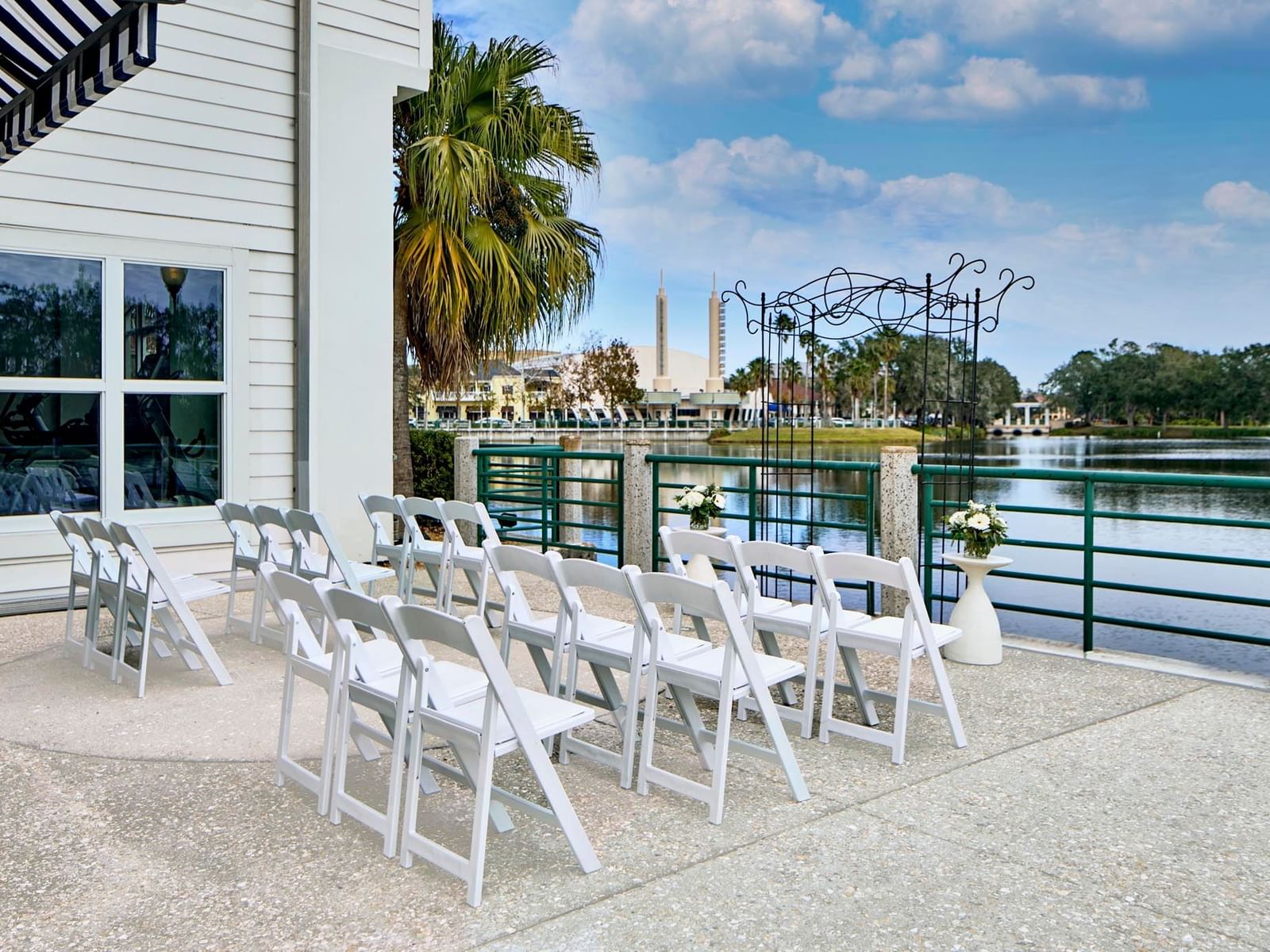 Lake Rianhard Terrace at the Inn at Celebration, with white chairs set up facing an arch by the waterfront