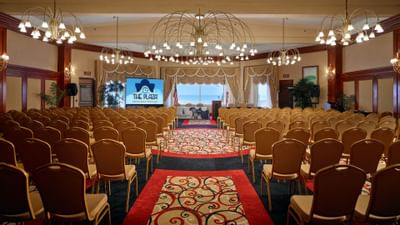 banquet hall with rows of chairs and projector in front