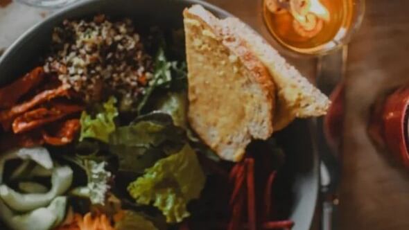 Bread served with salad on a table in 30 86 at Camp Creek Inn
