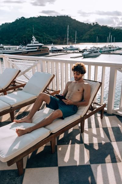 Man sitting on a sun lounger at Amaka Ocean Living Lodge