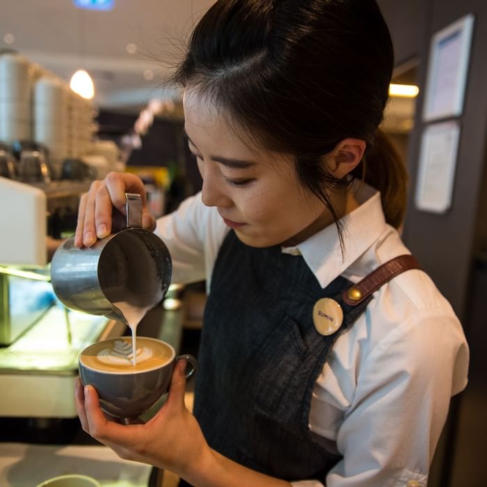 Close up on barista making coffee at Novotel Melbourne