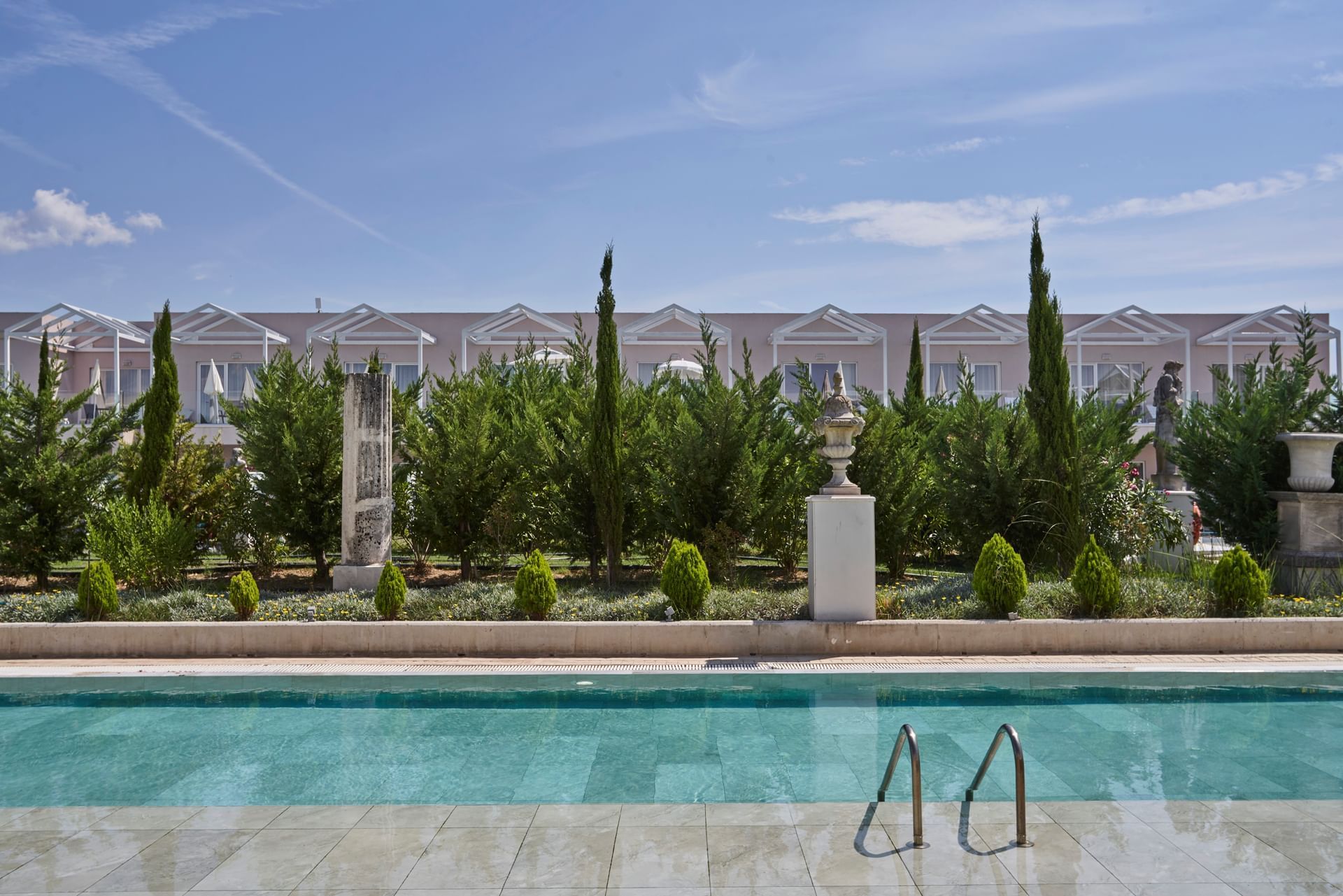 Outdoor pool by a garden area at Kairaba Sandy Villas