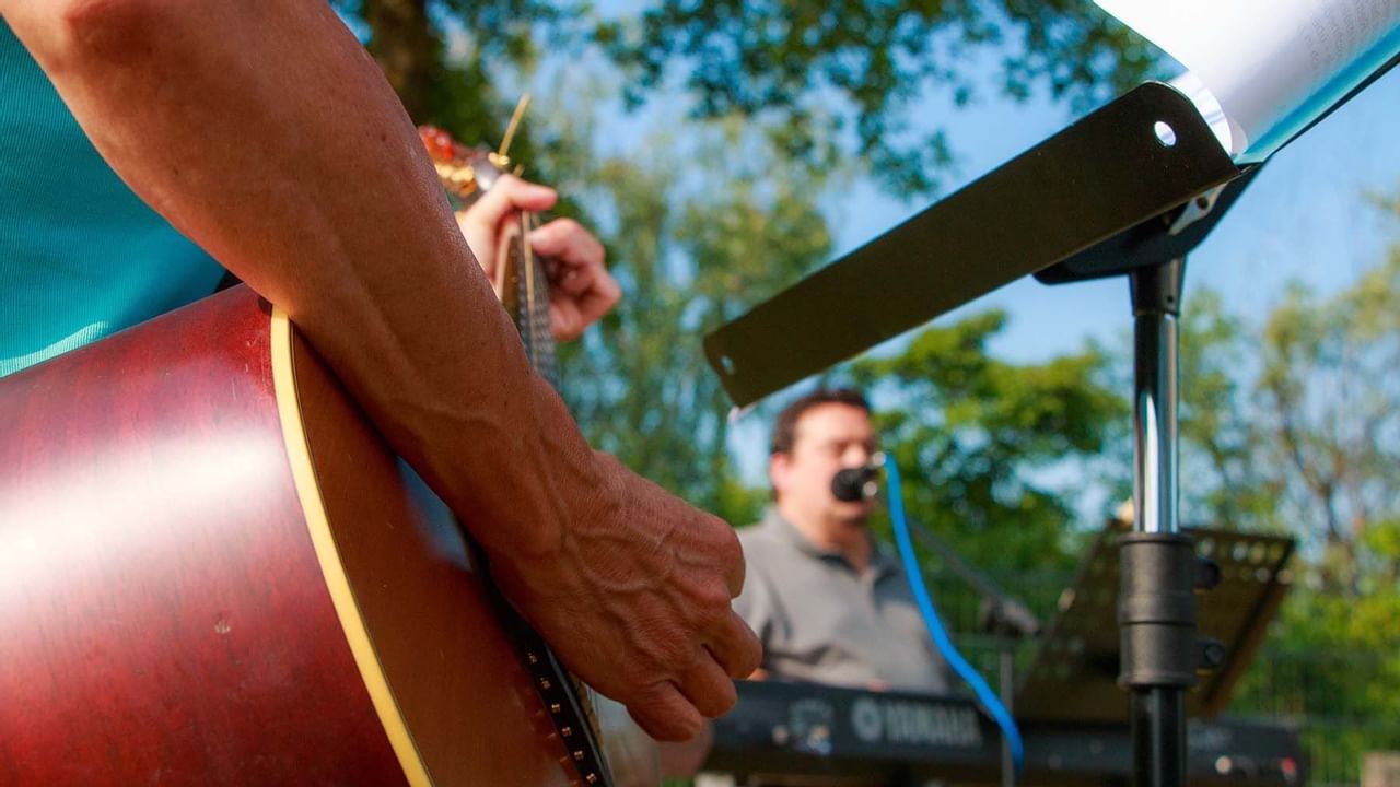 Close up of band member playing guitar during show