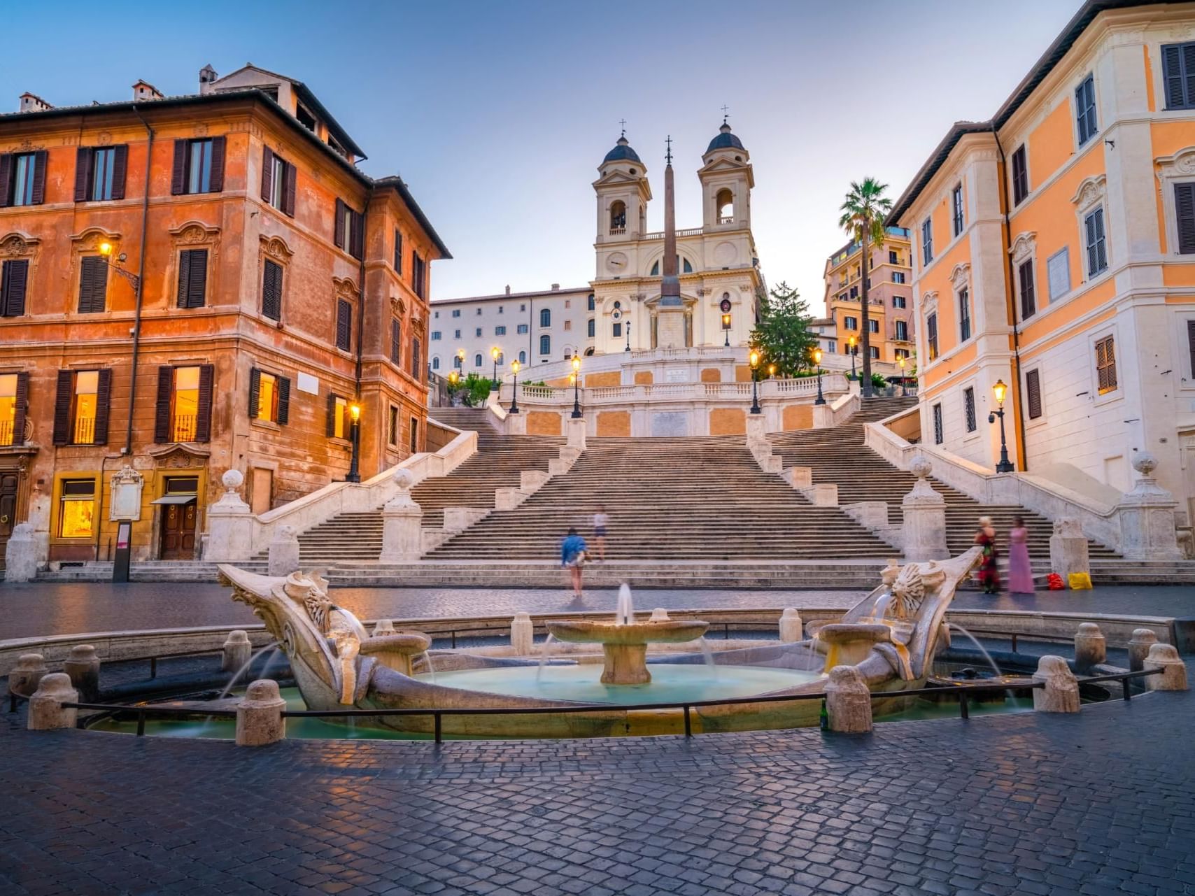 Landscape view of the Piazza di Spagna and Spanish Steps with a fountain near The Guardian Hotel