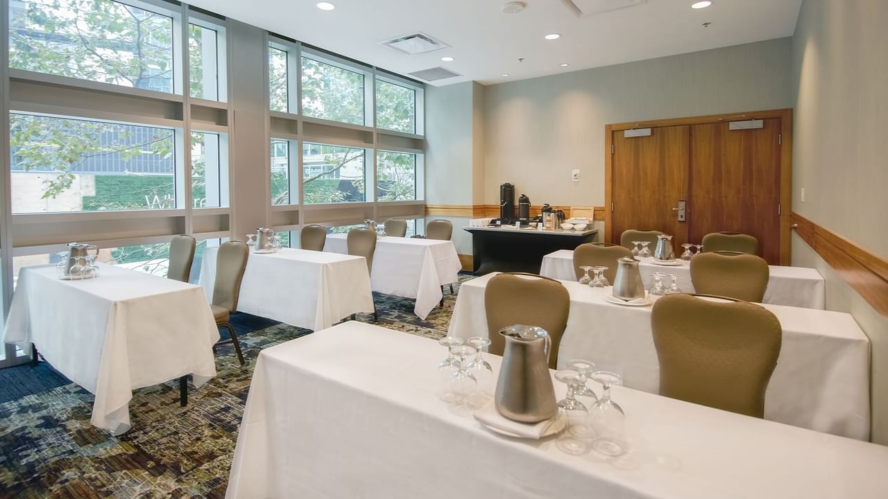 Meeting room with chairs, tables, and refreshments