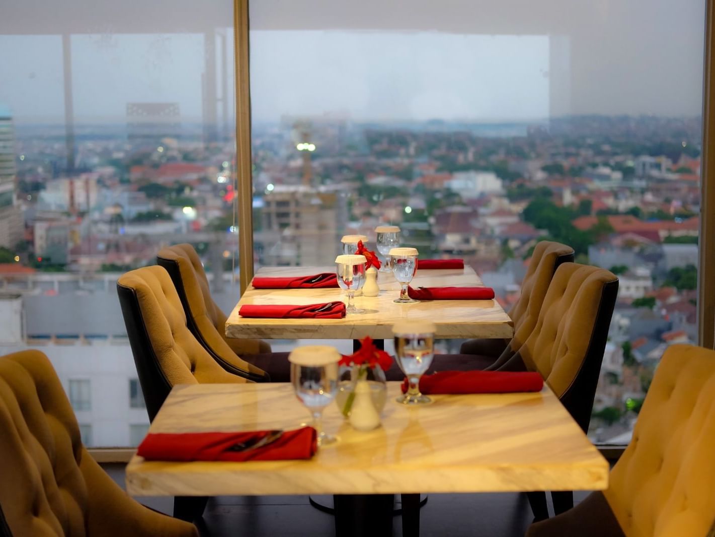 Dining tables and counter with city view in Gastro & Sky Bar at LK Hotel Simpang Lima