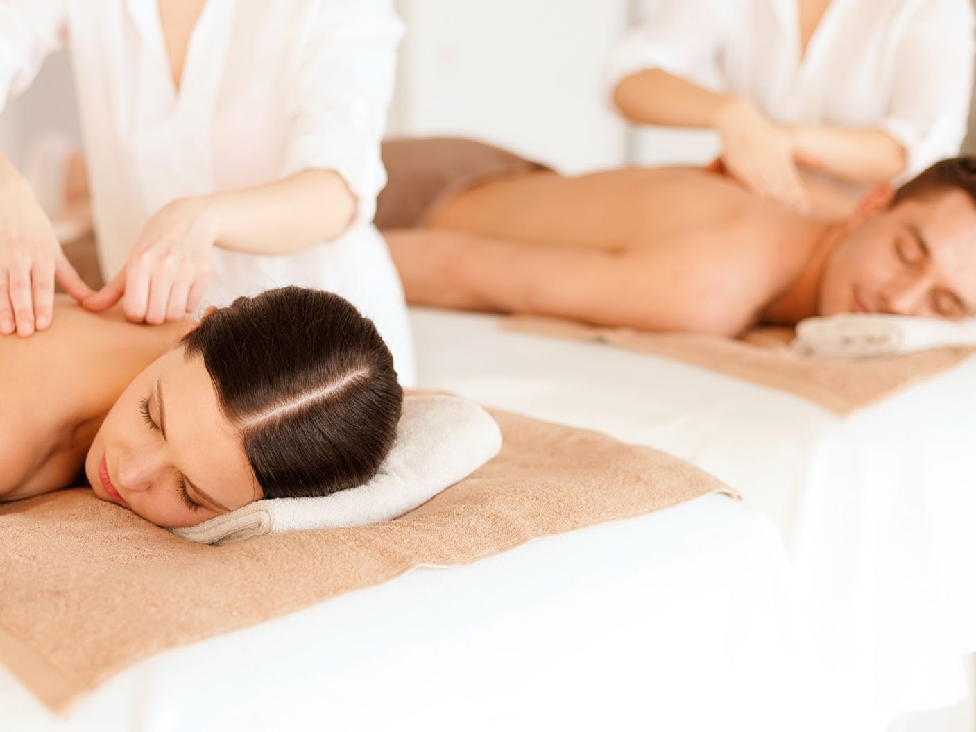 Two ladies having a body massage in the spa at Grove Hotel