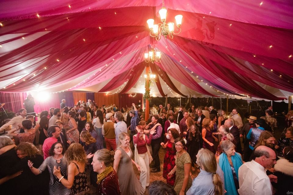 People dancing outdoor barn tent at The Heritage House Resort