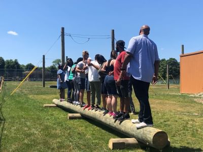 People balancing on a log near Honor’s Haven Retreat