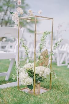 Outdoor wedding ceremony arranged with white flower decorations at Sebasco Harbor Resort