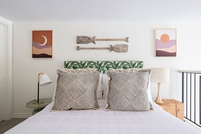 Cozy bed with nightstands & wall pictures in Superior Loft at Retro Suites Hotel