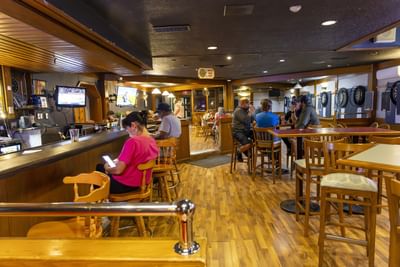 Patrons relaxing inside the cozy Haleys Lounge bar area with warm wood accents at Rodd Grand Yarmouth