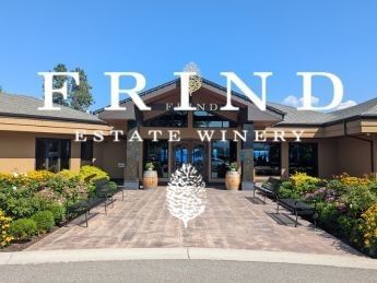 Entrance to Frind Estate Winery with lush gardens and a welcoming pathway.