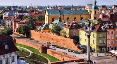 Distant view of the city with colorful buildings and an old defensive wall near Polonia Palace Hotel