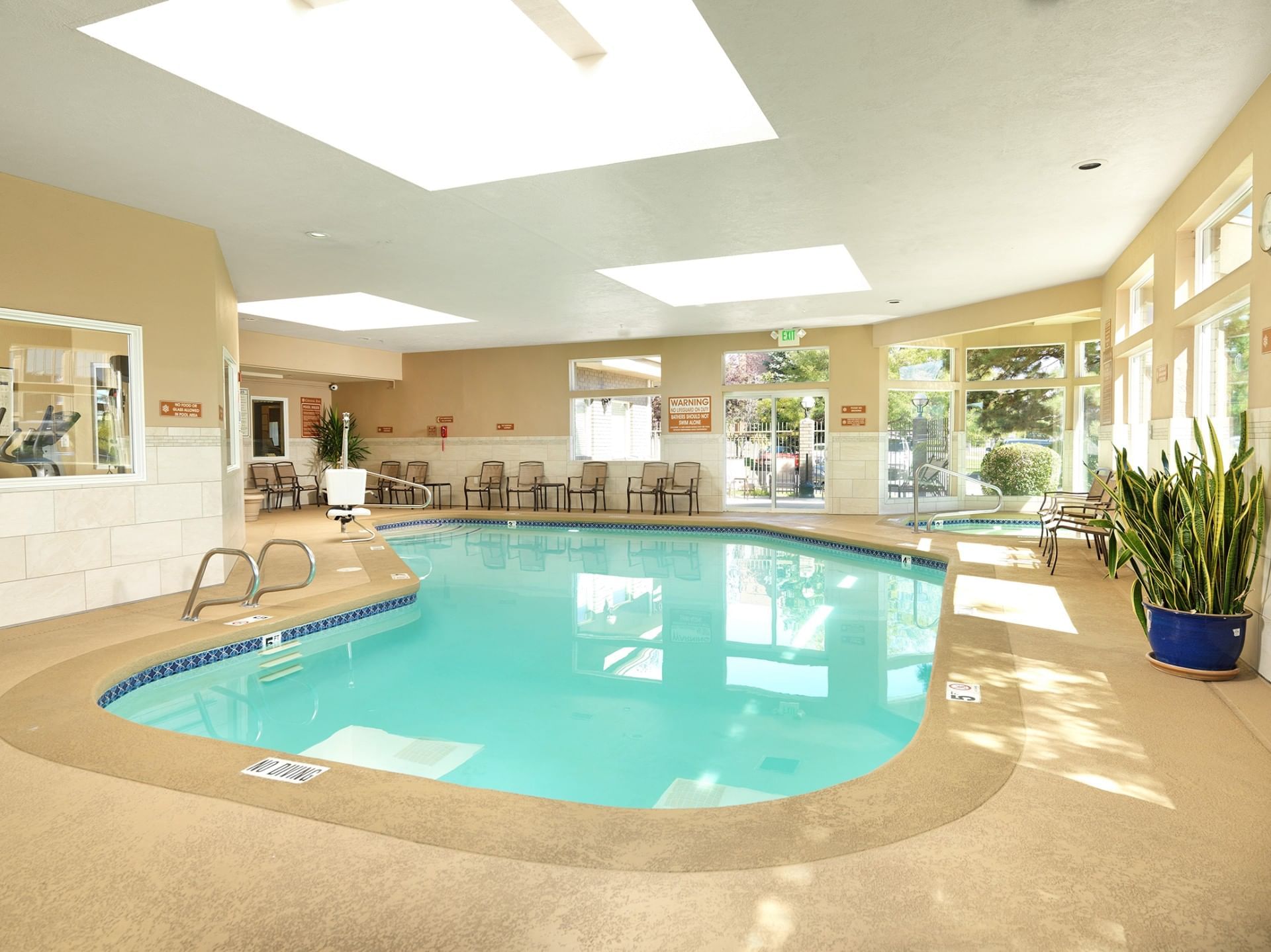 Indoor pool area with arranged chairs at Crystal Inn Salt Lake City
