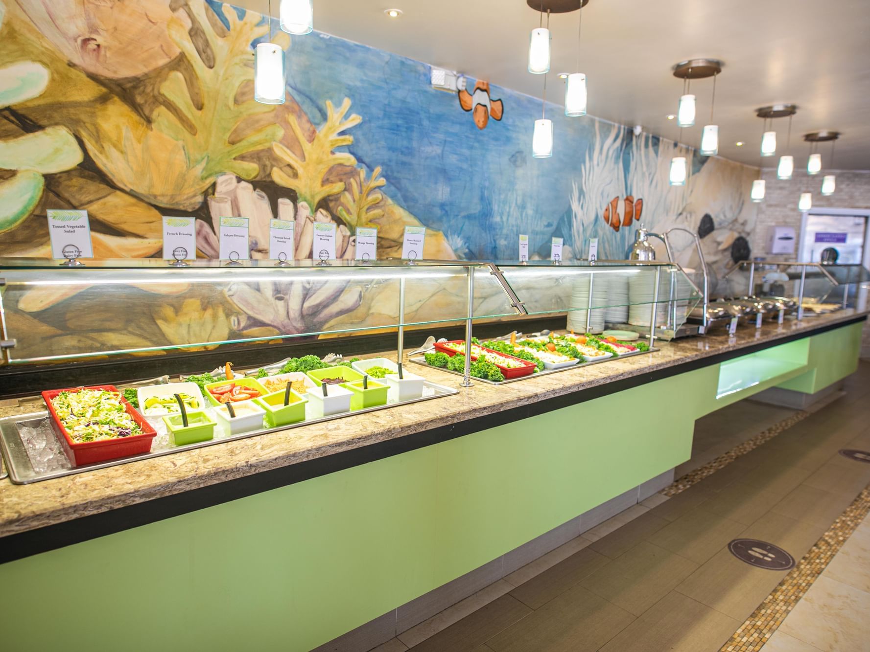 The Portside Buffet display by an underwater theme wall art at Holiday Inn Montego Bay