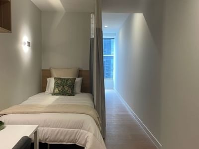 Bedroom with single bed and window within a 4 Bedroom Twin Share Apartment at UniLodge Brisbane City.