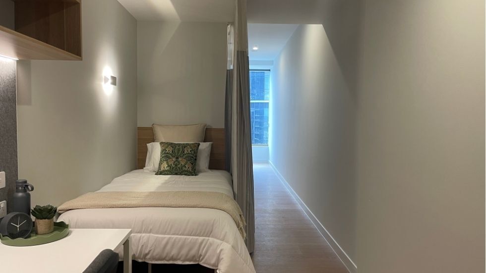 Bedroom with single bed and window within a 4 Bedroom Twin Share Apartment at UniLodge Brisbane City.