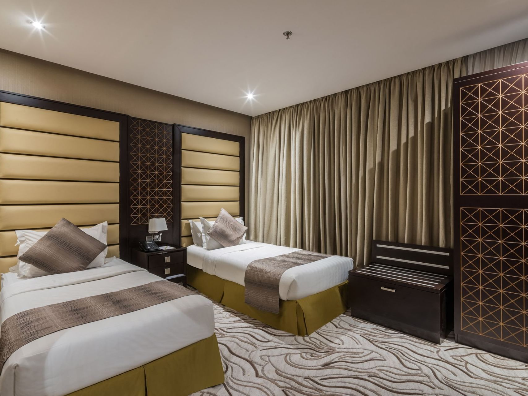 Two beds with carpeted floor in Family Suite at Warwick Al Khobar