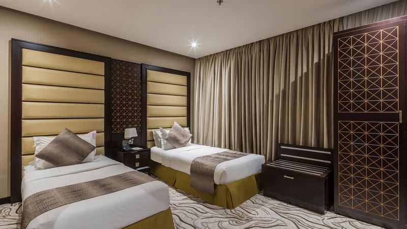 Two beds with carpeted floor in Family Suite at Warwick Al Khobar