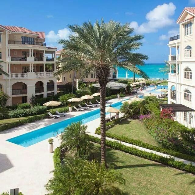 Pool with sunbeds & hotel exterior at The Somerset on Grace Bay