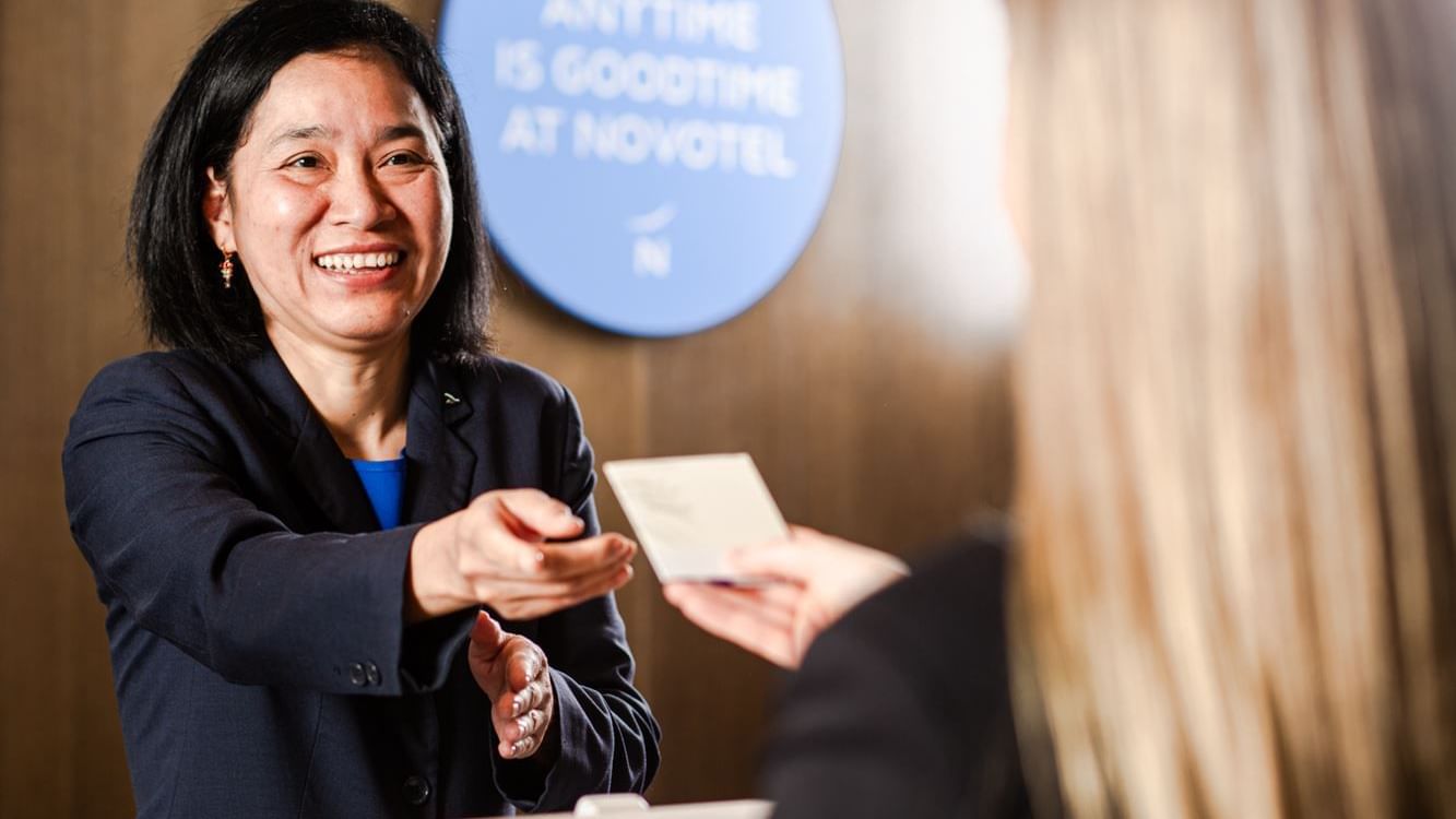 Receptionist handing over keycard at Novotel Glen Waverley