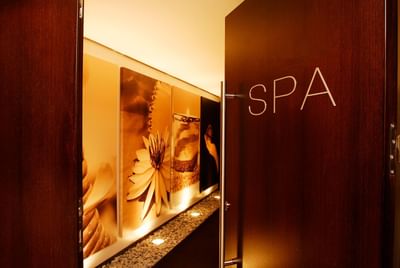 Holmes Place Spa entrance with soothing artwork, dim lighting, and a modern design at Hotel Cascais Miragem Health & Spa