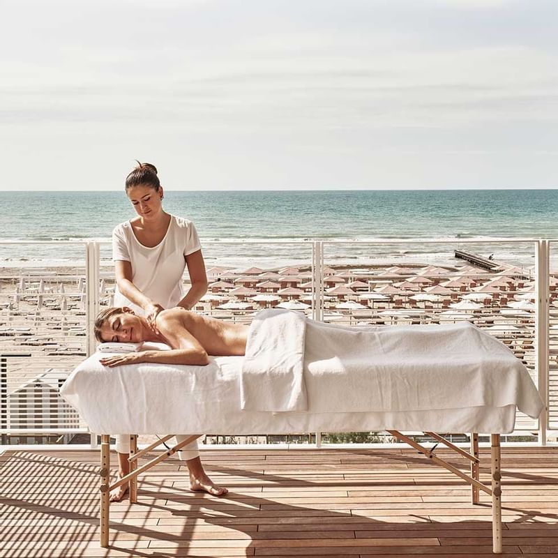 Lady receiving a massage on a sap balcony, Falkensteiner Hotels