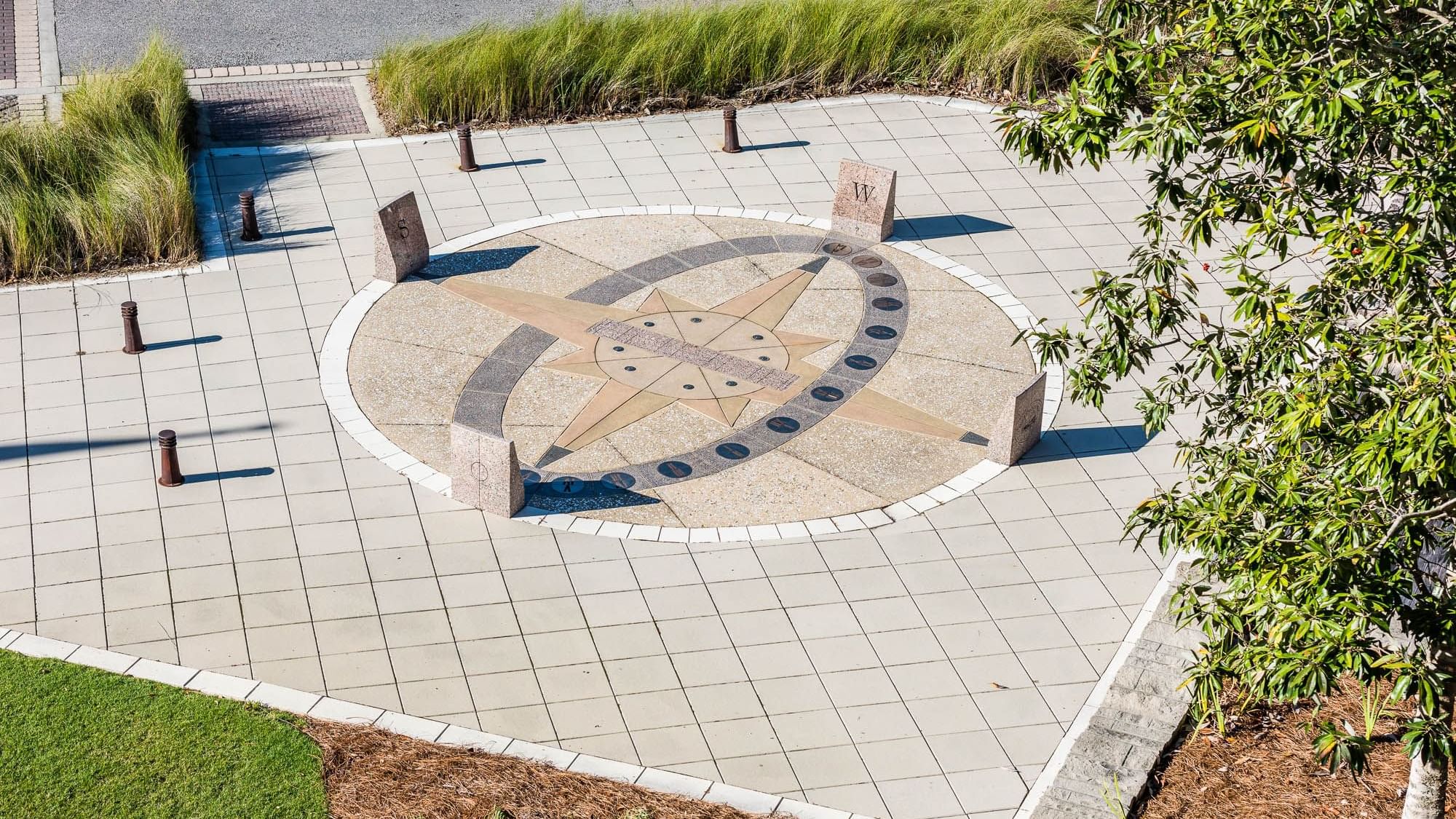 Distant view of a compass design on the floor outdoors at Watersound Inn