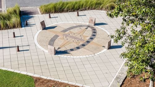 Distant view of a compass design on the floor outdoors at Watersound Inn