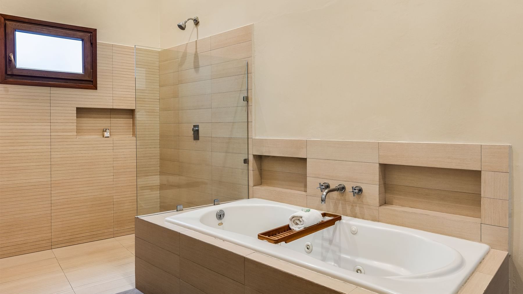 Modern bathroom featuring a spacious bathtub and a large walk-in shower at Curamoria Collection