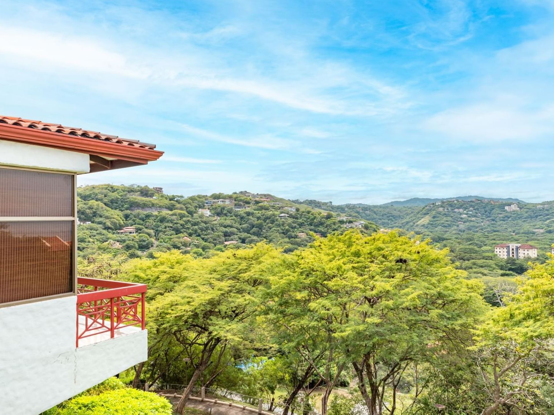 Balcony overlooking a valley of trees from Villas Sol Beach Resort