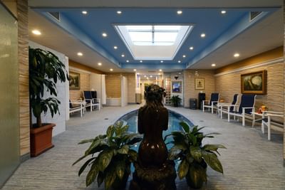 Spa lobby with fountain and sculpture.