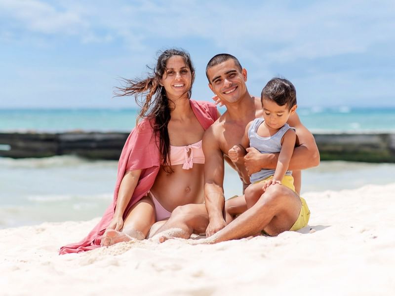 A family posing by the beach at The Reef Coco Beach