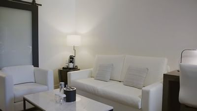 Living area with white sofa's in Suite King, The Nest Palo Alto