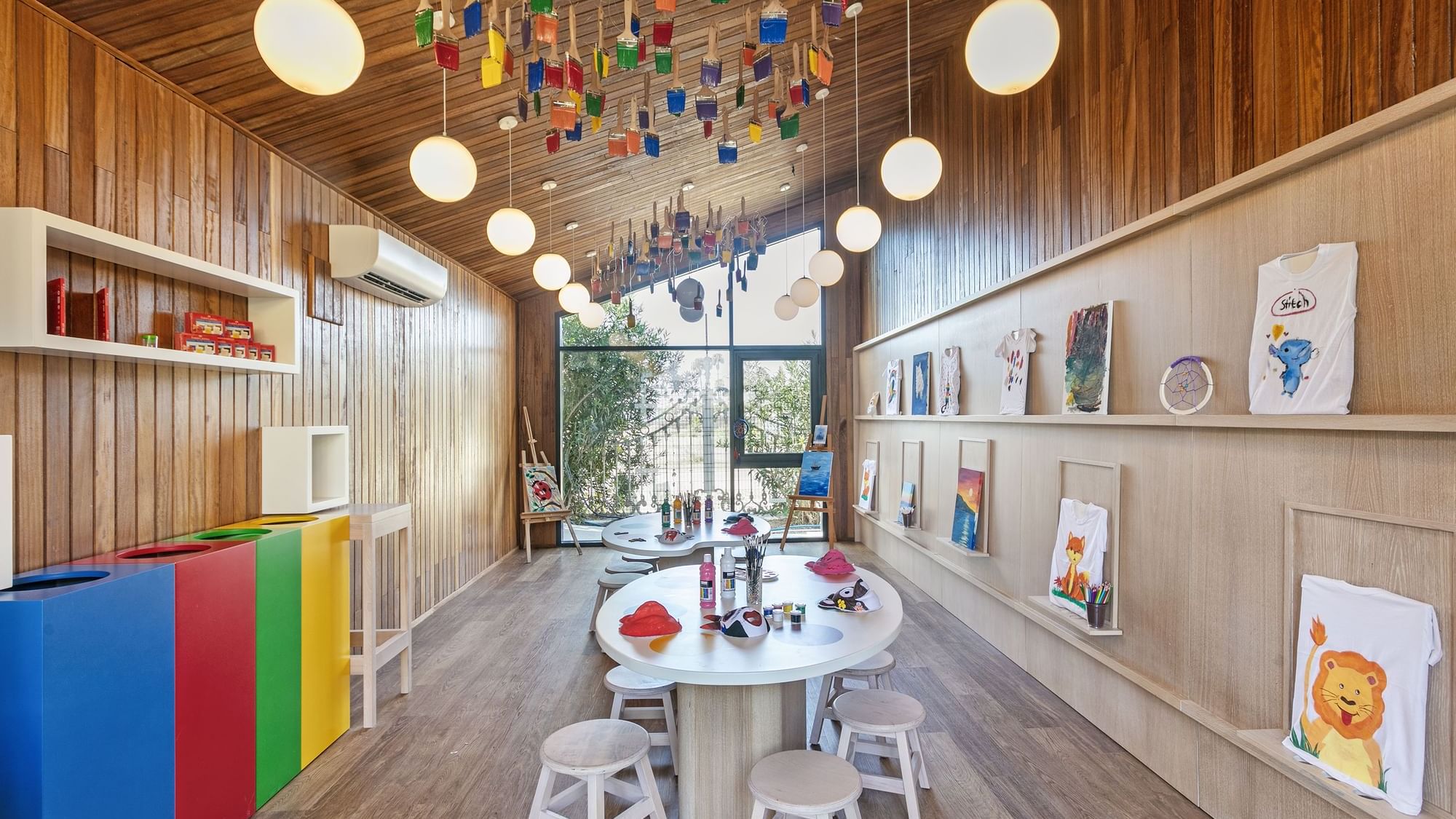 Children playing in a colorful indoor play area at Tini Kids Club, part of the luxurious Titanic Mardan Palace hotel.