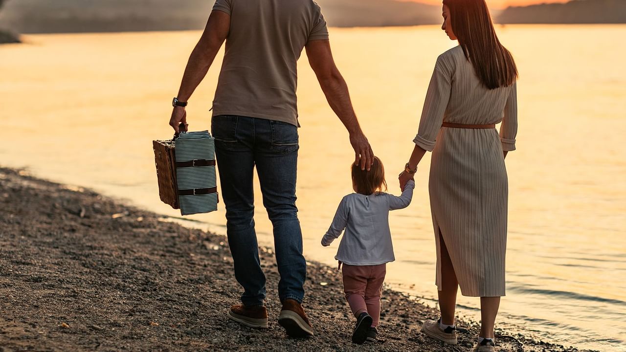 family walking on beach holding hands