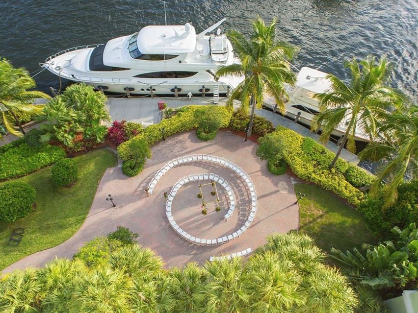 aerial shot of wedding venue next to river and yachts