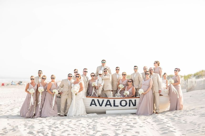 Large wedding party takes a photo on the beach near out South Jersey wedding venue