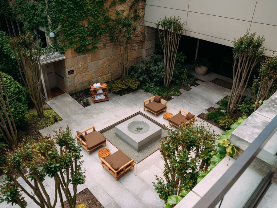 Aerial view of outdoor lounge area surrounded by lush greenery at The Umstead Hotel and Spa