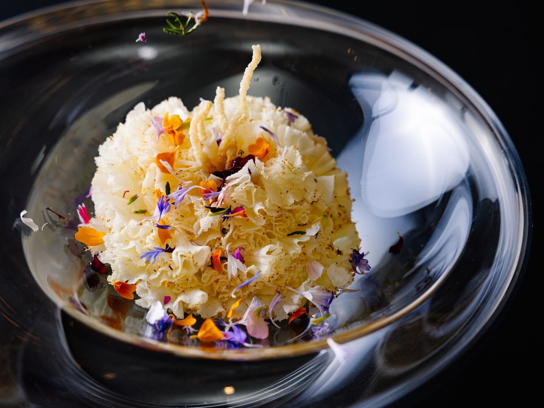Close-up of a fine dish inspired with flowers in Herons at The Umstead Hotel and Spa