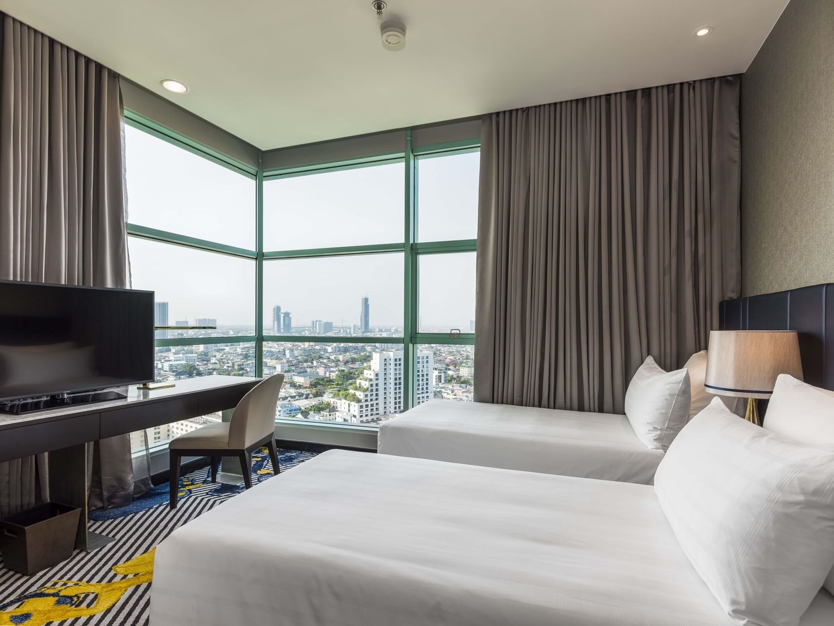Twin beds in Two Bedroom Suite City View at Chatrium Hotels