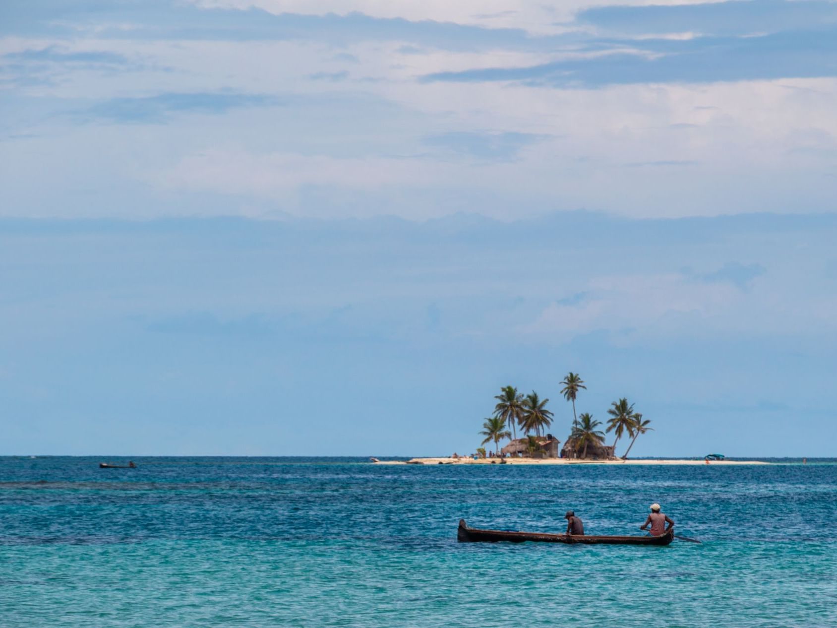 A fisherman boat in the sea and San Blas Island at the back