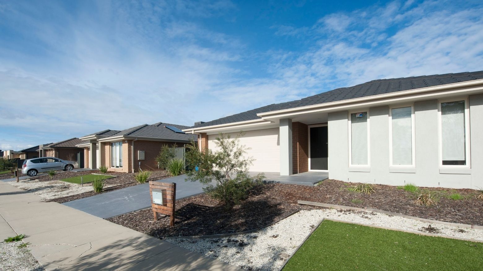 A row of modern houses with solar panels and a car parked in Shepparton.